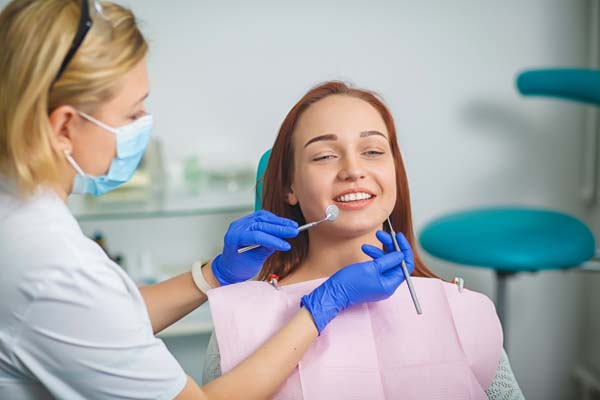 Dentist examining patient's teeth.