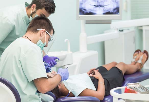 Dental team performing a procedure.