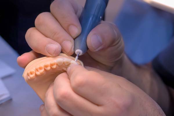 Dental technician crafting a denture.